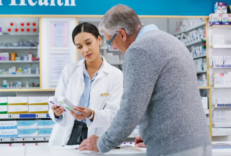 Pharmacist assisting customer with medication at counter